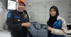 Petugas PT KAI menyerahkan laptop milik penumpang yang tertinggal di dalam kereta. (Sumber: Dok PT KAI Persero)