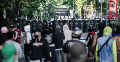 Massa aksi menantang pihak kepolisian dalam demonstrasi di depan Mako Brimob Polda Metro Jaya, Kwitang, Jakarta Pusat, Jumat, 29. Agustus 2025. (Sumber: Poskota/Bilal Nugraha Ginanjar)