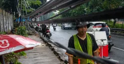Kabel-kabel listrik menjuntai di sepanjang Jalan Tahi Bonar (TB) Simatupang arah Pasar Rebo, Jakarta Selatan pada Selasa, 2 Desember 2025. (Sumber: POSKOTA | Foto: Dhiya Ahmad Fauzan/M2)