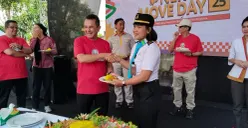 Direktur Utama LRT Jakarta, Roberto Akyuwen (kiri), memberikan potongan tumpeng kepada masinis. (Sumber: POSKOTA | Foto: Heri Effendi)