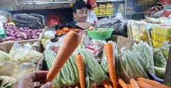 Pedagang sayuran melayani pembeli di Pasar Depok Jaya. Wortel jadi salah satu komoditas yang harganya naik jelang Natal 2025 dan Tahun Baru 2026. (Sumber: POSKOTA | Foto: Angga Pahlevi)