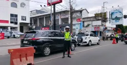 Anggota Satlantas Polres Cimahi melakukan pengamanan arus lalu lintas di kawasan Lembang, Kabupaten Bandung Barat, Sabtu 27 Desember 2025. (Sumber: Poskota | Foto: Gatot Poedji Utomo)
