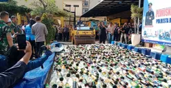 Polresta Bogor Kota bersama Forkopimda Kota Bogor memusnahkan 17 ribu botol miras hasil operasi tiga bulan terakhir di halaman Mako Polresta Bogor pada Selasa, 8 Juli 2025. (Sumber: POSKOTA | Foto: Sekar Putri Andini)