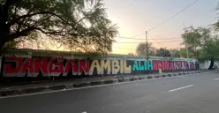 Coretan pada dinding menunjukan penolakan warga Kedoya Selatan terkait wacana alih fungsi lapangan sepak bola menjadi sarana olahraga Padel. (Sumber: Poskota/Pandi Ramedhan)
