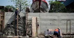 Pekerja menyelesaikan pembangunan tanggul mitigasi di area Docking Kapal Baywalk, Pluit, Jakarta, Kamis, 12 Juni 2025. (Sumber: Poskota/Bilal Nugraha Ginanjar)