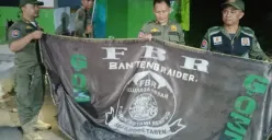 Petugas menurunkan atribut bendera ormas di wilayah Kecamatan Sawangan dan Kecamatan Bojongsari, Selasa dini hari, 20 Mei 2025. (Sumber: Dok. Polsek Bojongsari)