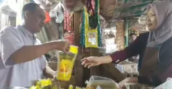 Pedagang minyak goreng di Pasar Badak Pandeglang saat melayani konsumen. (Sumber: Poskota/Samsul Fatoni)