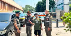 Sony, 32 tahun, diamankan Satpol PP DKI Jakarta saat mengatur arus kendaraan di kawasan pertigaan Cikini, Jakarta Pusat, Senin (8/6/2026). (Sumber: Poskota | Foto: M. Tegar Jihad)