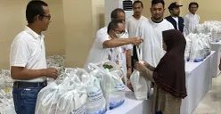 Wakil Wali Kota Jakarta Selatan, Ali Murtadho dan General Manager PLN UID Jakarta Raya, Moch Andy Adchaminoerdin, simbolis menyerahkan paket sembako murah dalam kegiatan 'Terang Berkah Ramadan'. (Sumber: Poskota/Guruh Nara Persada)