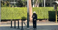 Seorang warga melindungi dirinya dari panas matahari dengan mengenakan jaket dan topi sinar matahari, Sabtu, 14 Maret 2026. (Sumber: Poskota/M. Tegar Jihad)