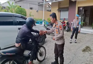 Kapolsek Bojonggede AKP Abdullah Syafiih didampingi Kanit Provos Polsek Bojonggede Iptu Tulus menerima pemudik asal Madura yang menitipkan motor di Mapolsek Bojonggede. (Sumber: Poskota/Angga Pahlevi)