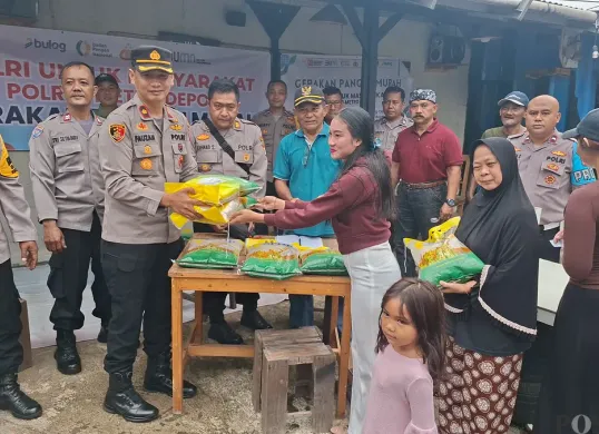Kapolsek Bojongsari, Kompol Fauzan Thohari, memberikan beras murah kepada masyarakat yang membeli. Program Pangan Murah tersebut mendapat animo masyarakat cukup tinggi. (Sumber: POSKOTA | Foto: Angga Pahlevi)