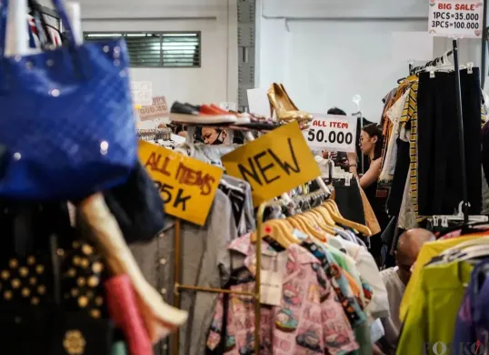 Pengunjung memilih pakaian yang dijual dalam acara Garage Sale di Pos Bloc, Jakarta, Minggu, 3 Agustus 2025. (Sumber: Poskota/Bilal Nugraha Ginanjar)