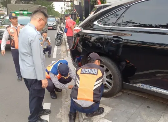 Petugas menggembol ban mobil yang terparkir sembarangan di Jalan Raya Margonda, Beji, Kota Depok, Kamis, 28 Agustus 2025. (Sumber: Dok. Warga)