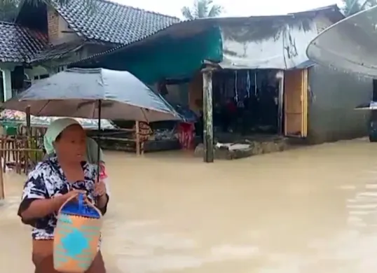 Sejumlah warga menerobos banjir di Desa Idaman, Kecamatan Patia, Pandeglang, saat evakuasi mandiri. (Sumber: Dok. BPBD Pandeglang)