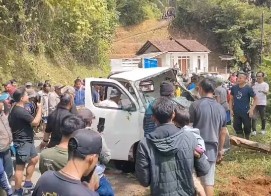 Warga berkerumun saat bangkai mobil pick up dievakuasi dari jurang sedalam 25 meter di jalur Garut - Pamengpeuk, kawasan Desa Karamatwangi, Kecamatan Cikajang, Sabtu, 18 Januari 2025. (Sumber: Dok. Humas Polres Garut)