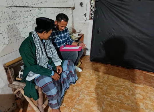 Tersangka Mustofa di rumahnya saat akan digelandang petugas Ditreskrimum ke Mapolda Banten. (Sumber: Polda Banten)