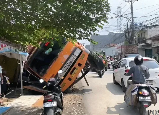 Truk bermuatan gypsum terguling di Jalan Kali Abang Tengah, Kota Bekasi, dan menimpa dua warung di sebelahnya pada Senin, 23 Juni 2025. (Sumber: POSKOTA | Foto: Nurpini Aulia Rapika)