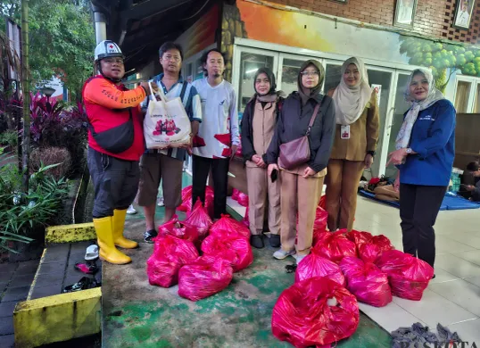 PMI Jakarta Selatan membagikan bantuan kepada korban pengungsi banjir di RPTRA Bango, Pondok Labu, Jakarta Selatan, Selasa malam, 4 Maret 2025. (Sumber: Poskota/Angga Pahlevi)