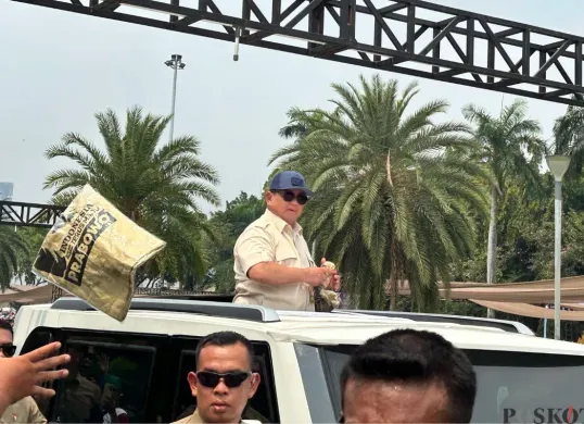 Presiden Prabowo Subianto saat melempar-lemparkan baju kepada massa buruh di Kawasan Monas, Jakarta Pusat, Kamis, 1 Mei 2025. (Sumber: Poskota/M. Tegar Jihad)