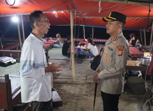 Kapolres Pandeglang, AKBP Dhyno Indra Setyadi saat berbincang dengan para pedagang saat patroli di wisata kuliner Teluk, Labuan. (Sumber: Dok. Polres Pandeglang)
