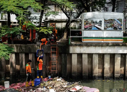 Petugas Unit Penanganan Sampah Badan Air (UPS Badan Air) Kecamatan Tanah Abang membersihkan tumpukan sampah yang mengendap di aliran Kali Cideng, Tanah Abang, Jakarta, Selasa, 13 Mei 2025. (Sumber: Poskota/Bilal Nugraha Ginanjar)