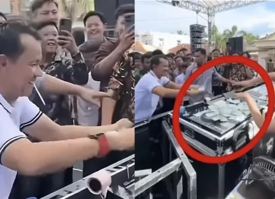 Tangkapan layar video yang memperlihatkan Hatami, anggota DPRD Lampung Utara, sedang menyawer DJ Rere Monique dengan pecahan Rp50 ribu di acara khitanan. Aksi tersebut menuai kritik publik. (Sumber: X/@ilhampid)