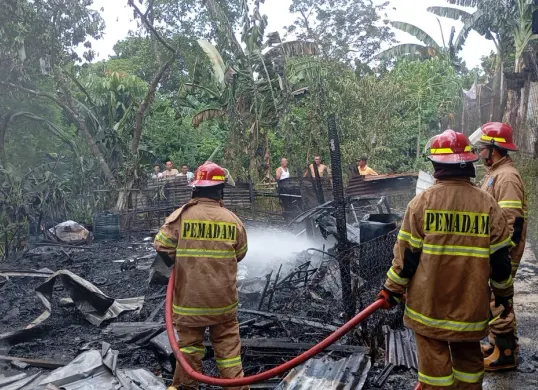 Petugas Damkar Depok melakukan pendinginan di lapak barang bekas yang hangus terbakar hingga rata dengan tanah. (Sumber: Istimewa)