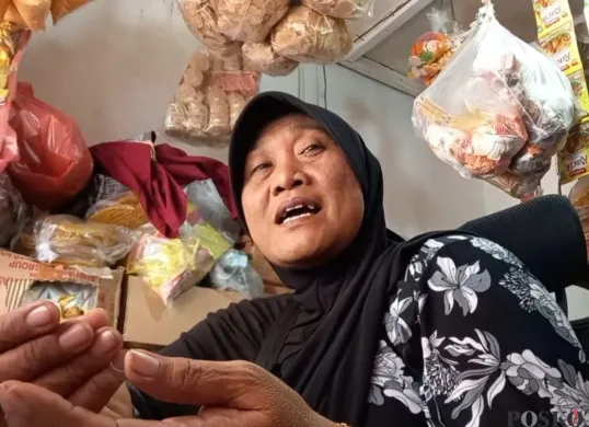 Ririn, 58 tahun, pedagang Pasar Patra, Duri Kepa, Kebon Jeruk Jakarta Barat, diwawancarai, Kamis, 13 November 2025. (Sumber: Poskota/Pandi Ramedhan)