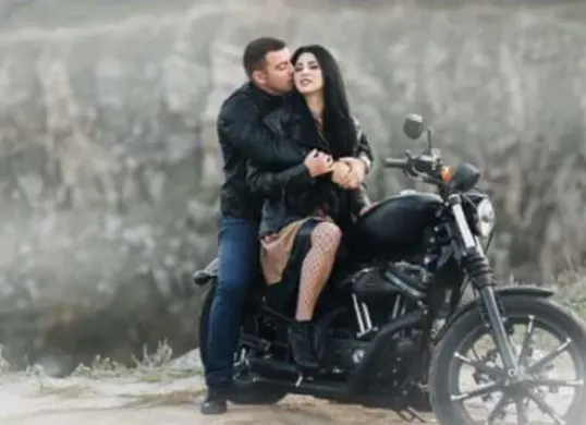 Pose santai, motor matte hitam, latar sunset hasil edit via Gemini AI (Sumber: Dok/Gemini AI)