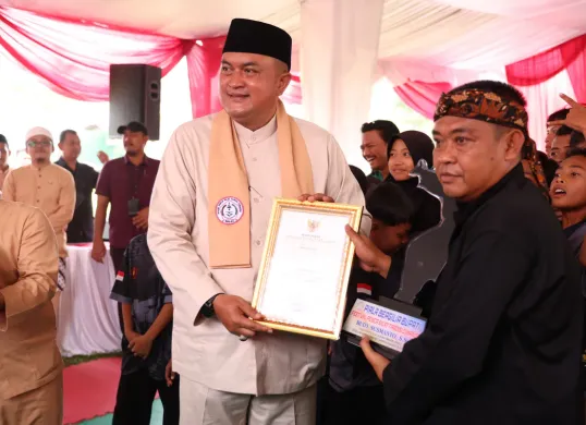 Bupati Bogor, Rudy Susmanto menyerahkan penghargaan saar gelar festival kejuaran pencak silat di Cimande, Kabupaten Bogor. (Sumber: Dok. Pemkab Bogor)