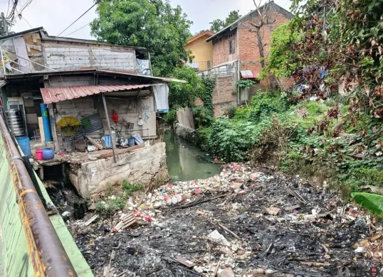 Tumpukan sampah menutupi aliran Kalibaru di Jalan Kalibaru Timur, Medan Satria, Kota Bekasi, Rabu, 17 September 2025. (Sumber: Poskota/Nurpini Aulia Rapika)
