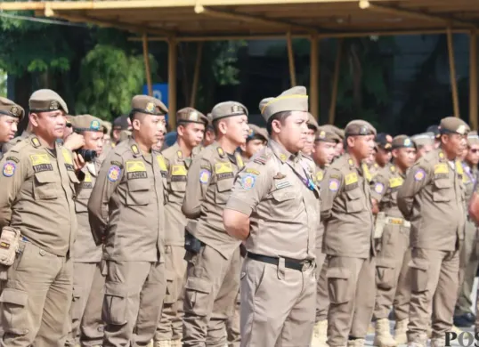 Personel Satpol PP Kabupaten Tangerang sedang melaksanakan apel sebelum diberangkatkan ke titik lokasi pengamanan masing-masing. (Sumber: Poskota/Veronica Prasetio)
