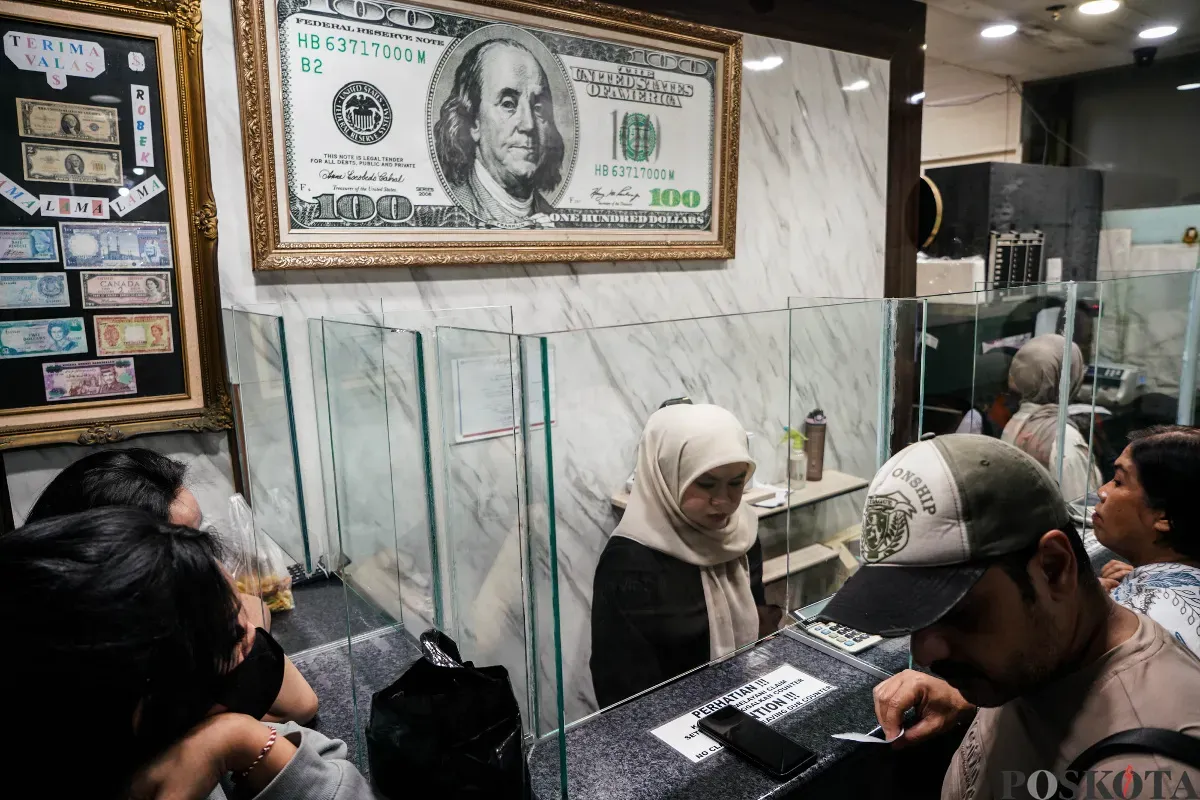 Petugas memeriksa pecahan uang dollar AS di tempat penukaran uang valuta asing PT Valuta Artha Mas di Kuningan, Jakarta Selatan, Rabu, 9 April 2025. (Sumber: Poskota/ Bilal Nugraha Ginanjar)