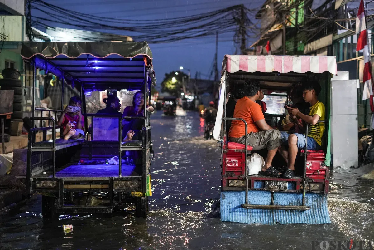 Warga melintasi genangan rob di Muara Angke, Jakarta Utara, Senin, 18 Agustus 2025. (Sumber: Poskota/Bilal Nugraha Ginanjar)