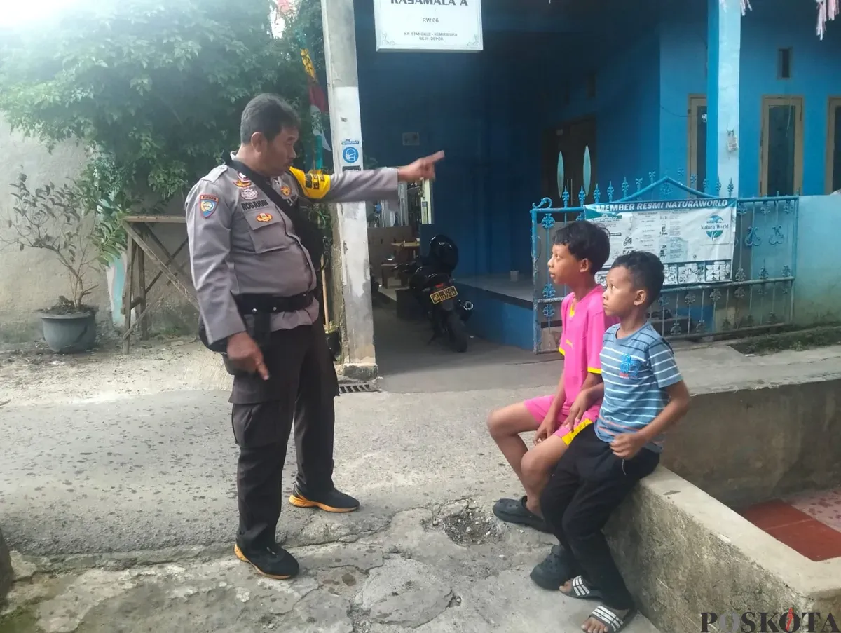 Petugas kepolisian berbicara dengan dua orang bocah di TKP penjambretan HP, Kampung Stangkle, RT 01 RW 06, Kelurahan Kemirimuka, Kecamatan Beji, Kota Depok. (Sumber: Poskota/Angga Pahlevi)