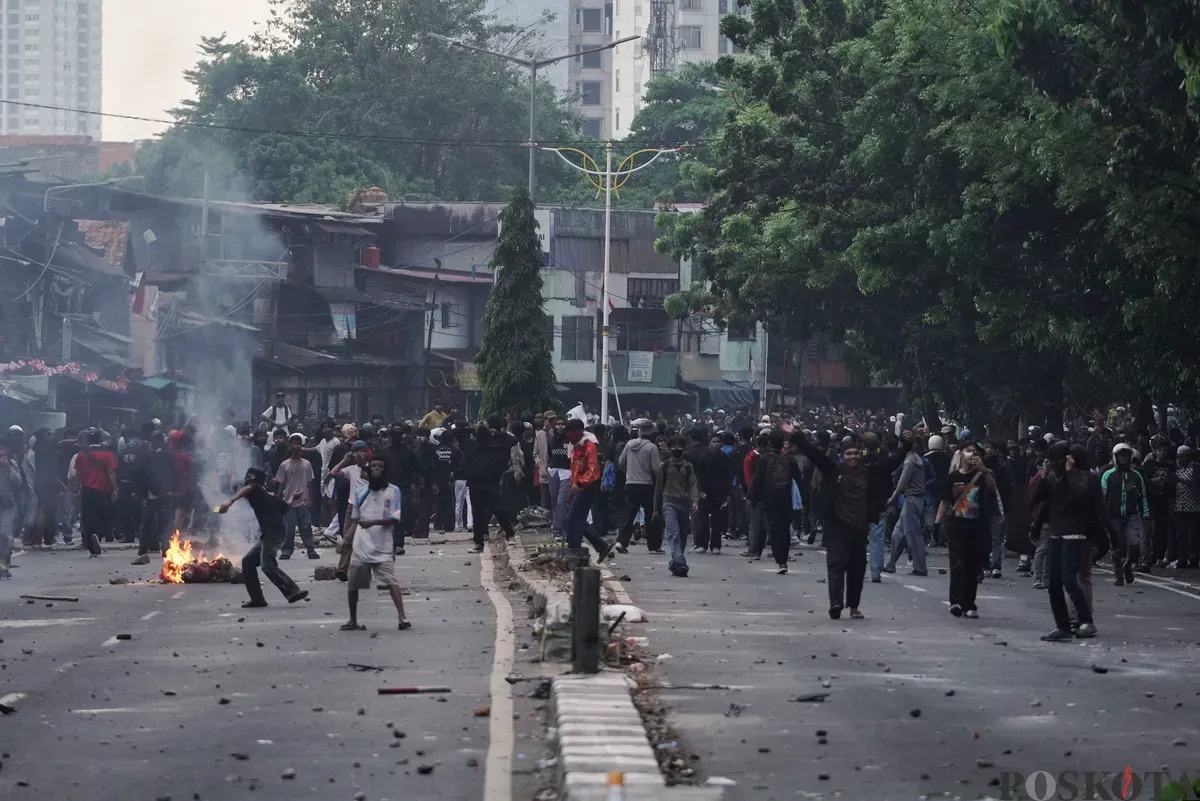 Sejumlah massa aksi berhadapan dengan aparat saat demo di belakang DPR dan Pejompongan, Jakarta, Senin, 25 Agustus 2025. (Sumber: Poskota/Bilal Nugraha Ginanjar)