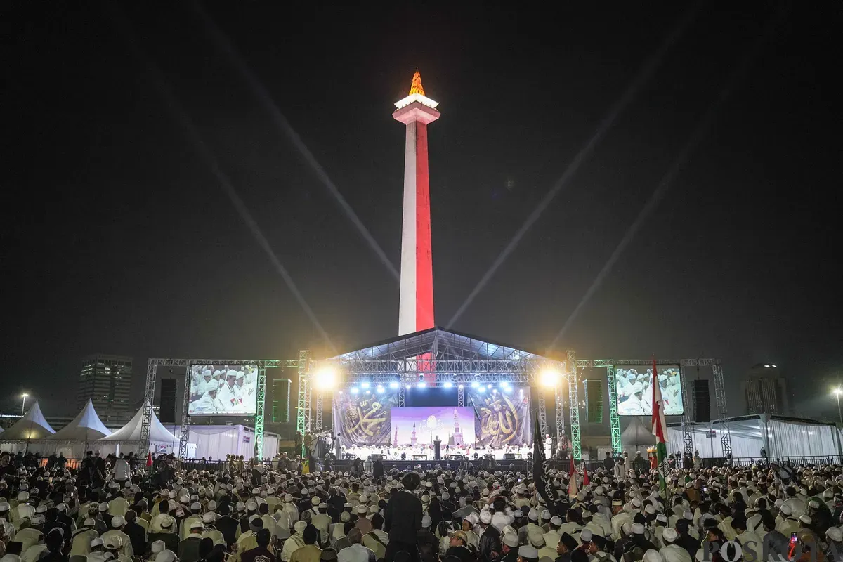 Peserta aksi reuni 212 bersholawat dan melaksanakan sholat isya berjamaah di Silang Monas, Selasa, 2 Desember 2025. (Sumber: Poskota/Bilal Nugraha Ginanjar)