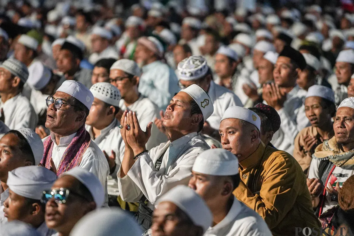 Peserta aksi reuni 212 bersholawat dan melaksanakan sholat isya berjamaah di Silang Monas, Selasa, 2 Desember 2025. (Sumber: Poskota/Bilal Nugraha Ginanjar)