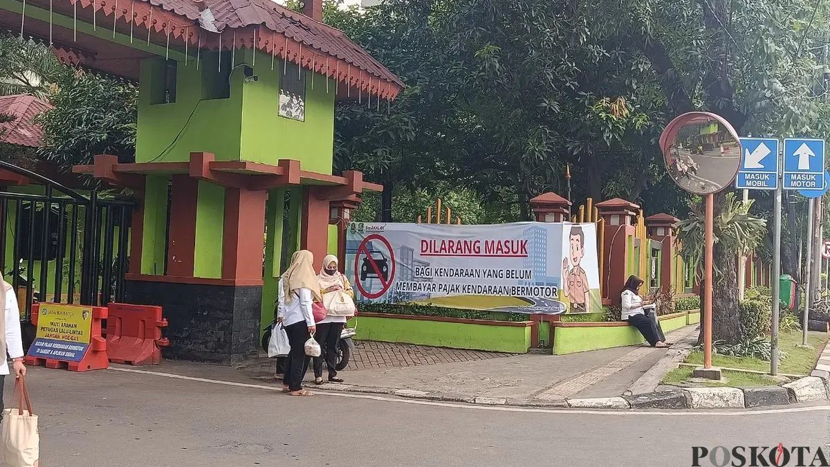 Pemkot Bekasi memasang spanduk sosialisasi larangan kendaraan belum bayar pajak masuk kantor. (Sumber: Poskota/Nurpini Aulia Rapika)