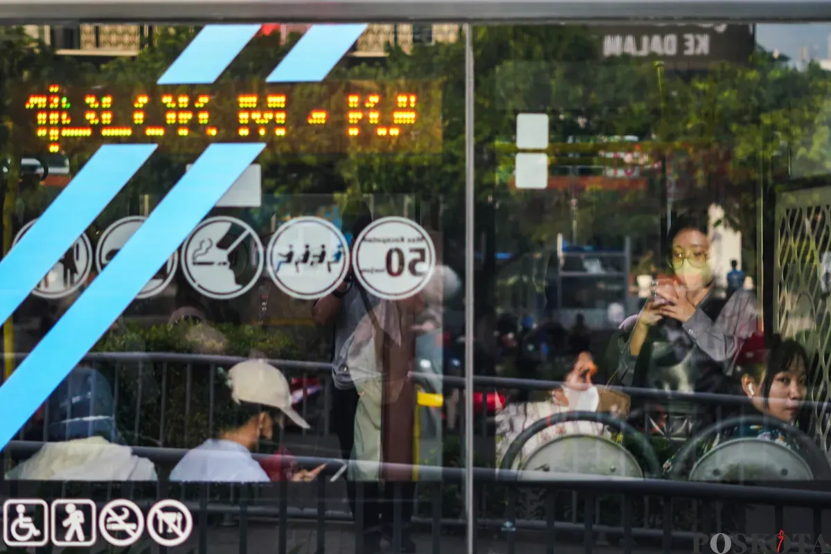 Pekerja menaiki bus transjakarta saat pulang kerja di Jalan MH Thamrin, Jakarta, Senin, 22 Desember 2025. (Sumber: Poskota/Bilal Nugraha Ginanjar)