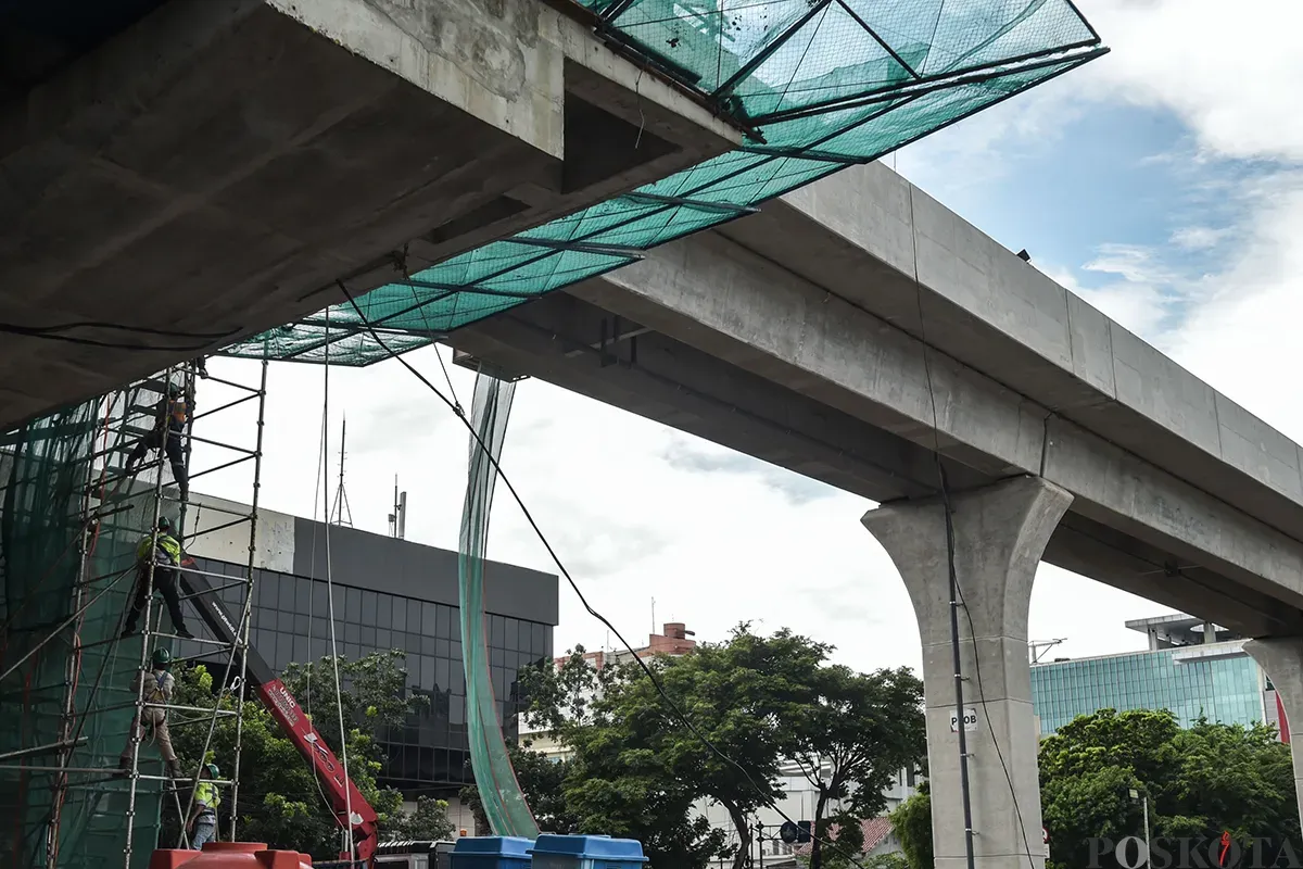 Pekerja menyelesaikan pembangunan stasiun kereta ringan atau Light Rail Transit (LRT) Jakarta fase 1B rute Velodrome-Manggarai di Pramuka, Jakarta Timur, Senin, 13 Januari 2025. (Sumber: Poskota/ Bilal Nugraha Ginanjar)