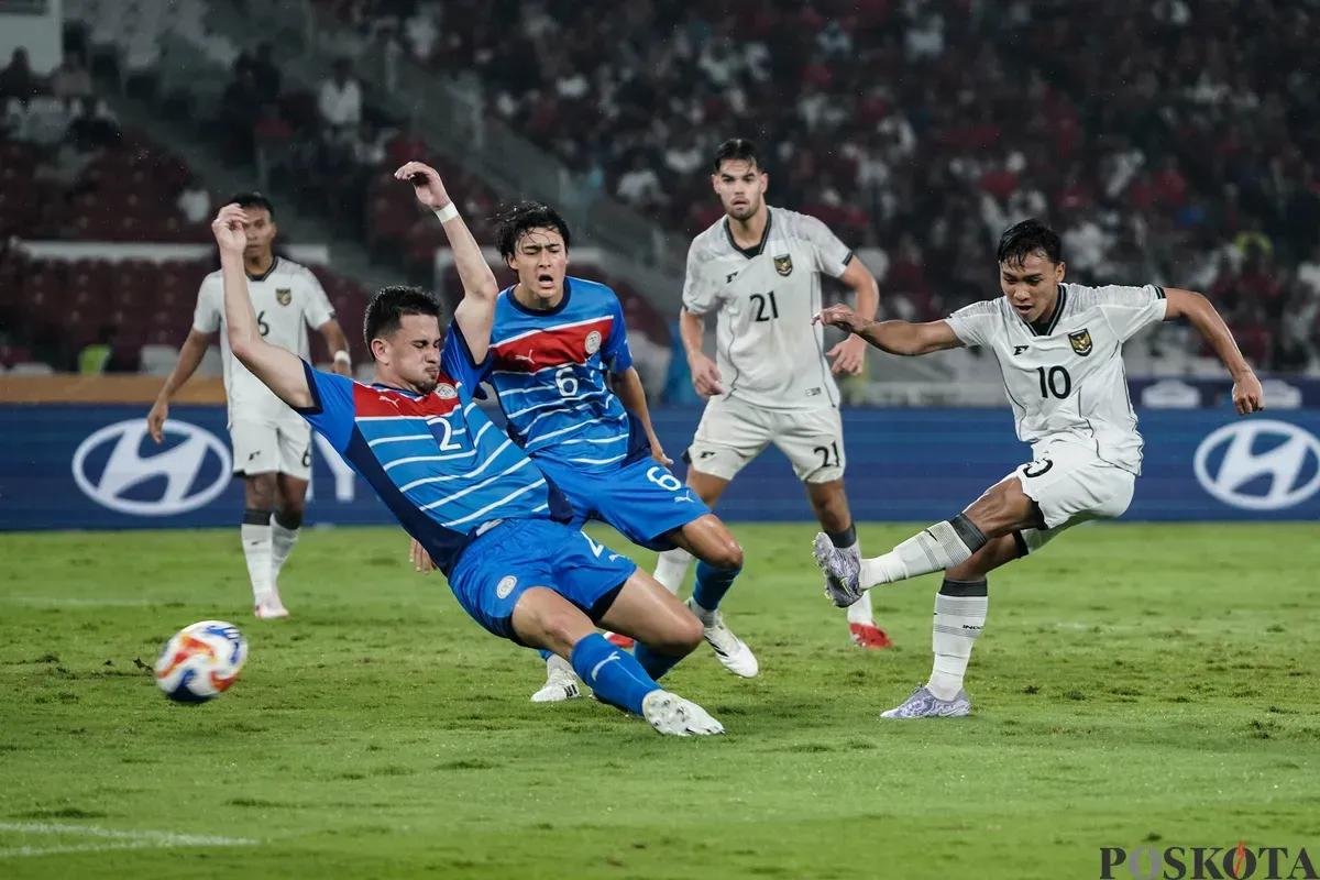 Pesepak bola Timnas U-23 Indonesia Arkhan Fikri menedang bola diantara pemain Timnas U-23 Filipina  pada pertandingan penyisihan Grup A Piala AFF U-23 2025 di Stadion Utama Gelora Bung Karno (SUGBK), Senayan, Jakarta, Jumat (18/7/2025). (Sumber: Poskota/Bilal Nugraha Ginanjar)