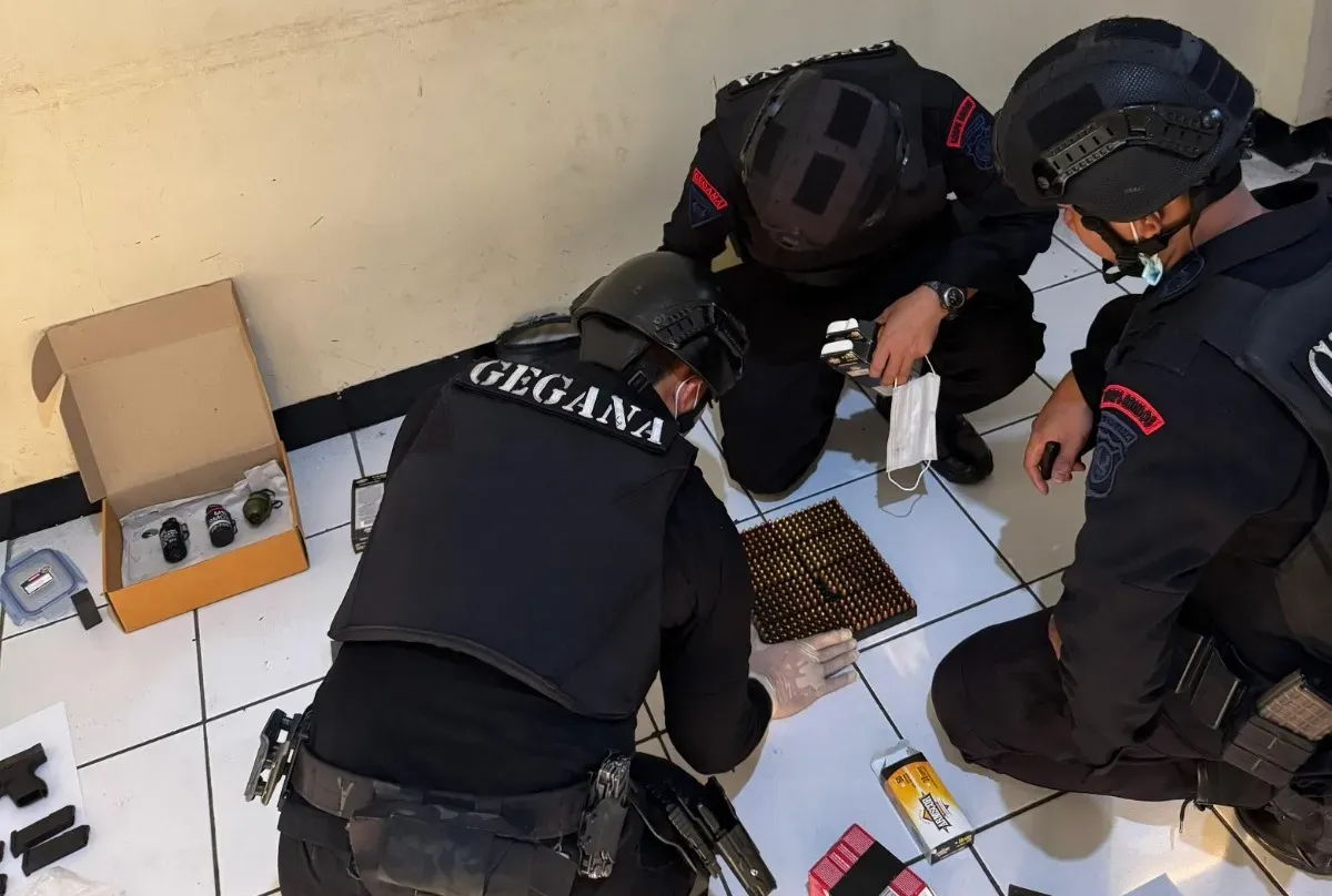 Detasemen Gegana Brimob Mabes Polri memeriksa senjata dan peluru dari koper WNA FIlipina yang menggemparkan warga Pasar Minggu, Jakarta Selatan. (Sumber: Polsek Pasar Minggu)