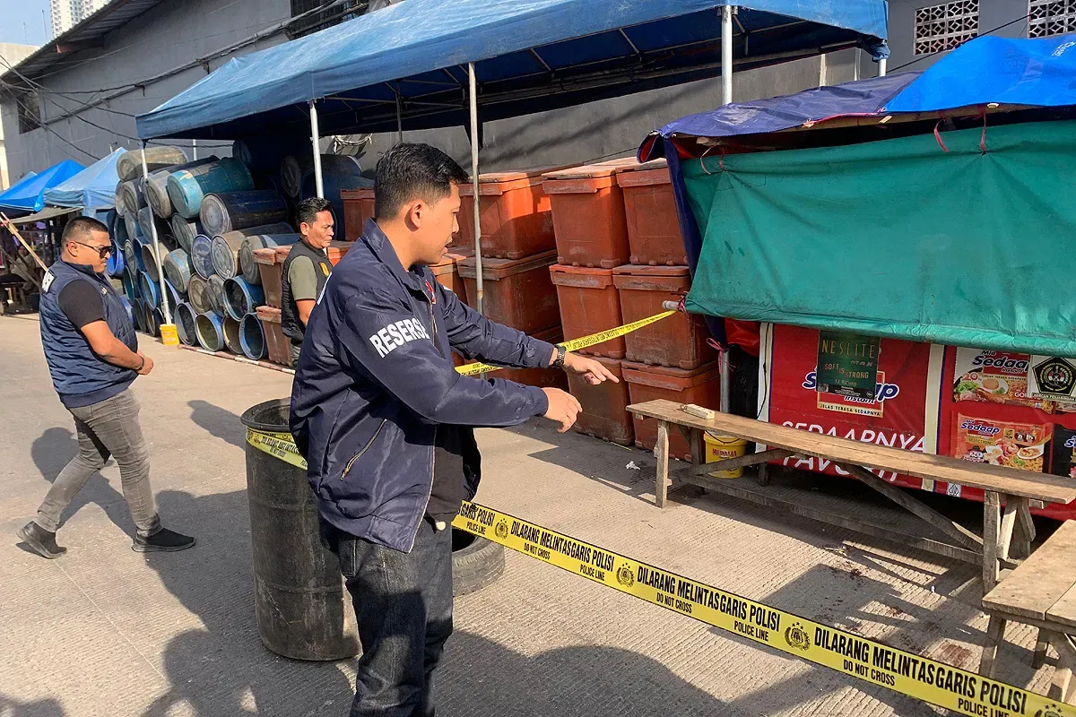 Petugas memasang garis polisi di lokasi pembunuhan seorang pria berinisial ABT, 39 tahun, di kawasan Tempat Pelelangan Ikan (TPI) Muara Angke, Pluit, Penjaringan, Jakarta Utara. (Sumber: Dok Polres Pelabuhan Tanjung Priok)