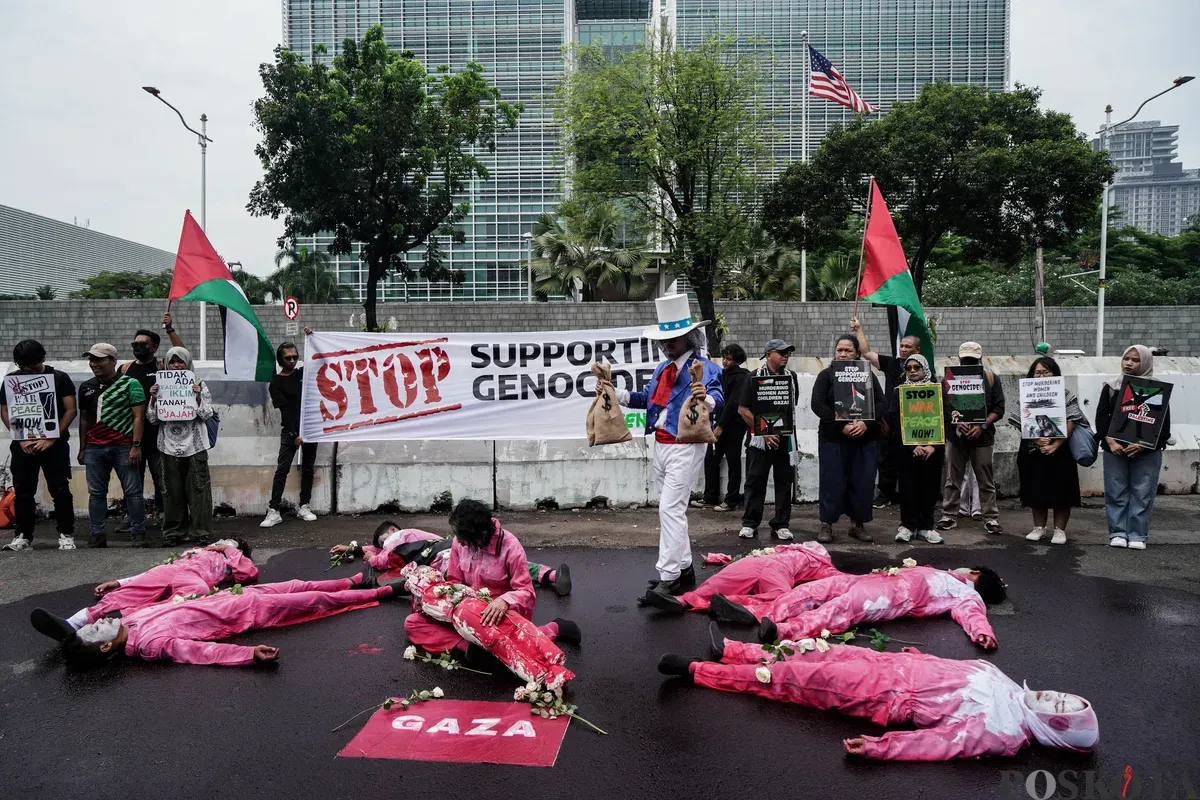 Sejumlah peserta aksi teatrikal dalam rangka unjuk rasa bela Palestina di depan Kedutaan Besar Amerika Serikat, Jakarta, Kamis, 19 Juni 2025. (Sumber: Poskota/Bilal Nugraha Ginanjar)