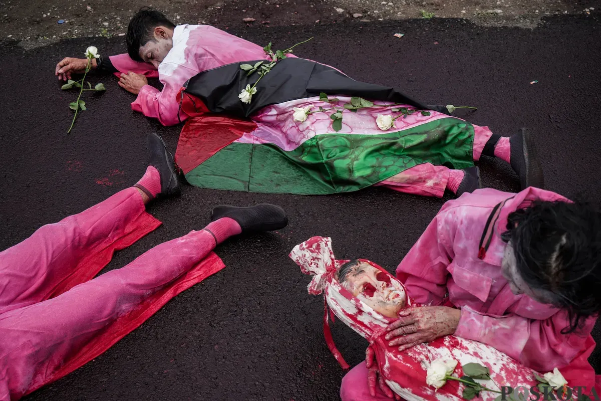 Sejumlah peserta aksi teatrikal dalam rangka unjuk rasa bela Palestina di depan Kedutaan Besar Amerika Serikat, Jakarta, Kamis, 19 Juni 2025. (Sumber: Poskota/Bilal Nugraha Ginanjar)
