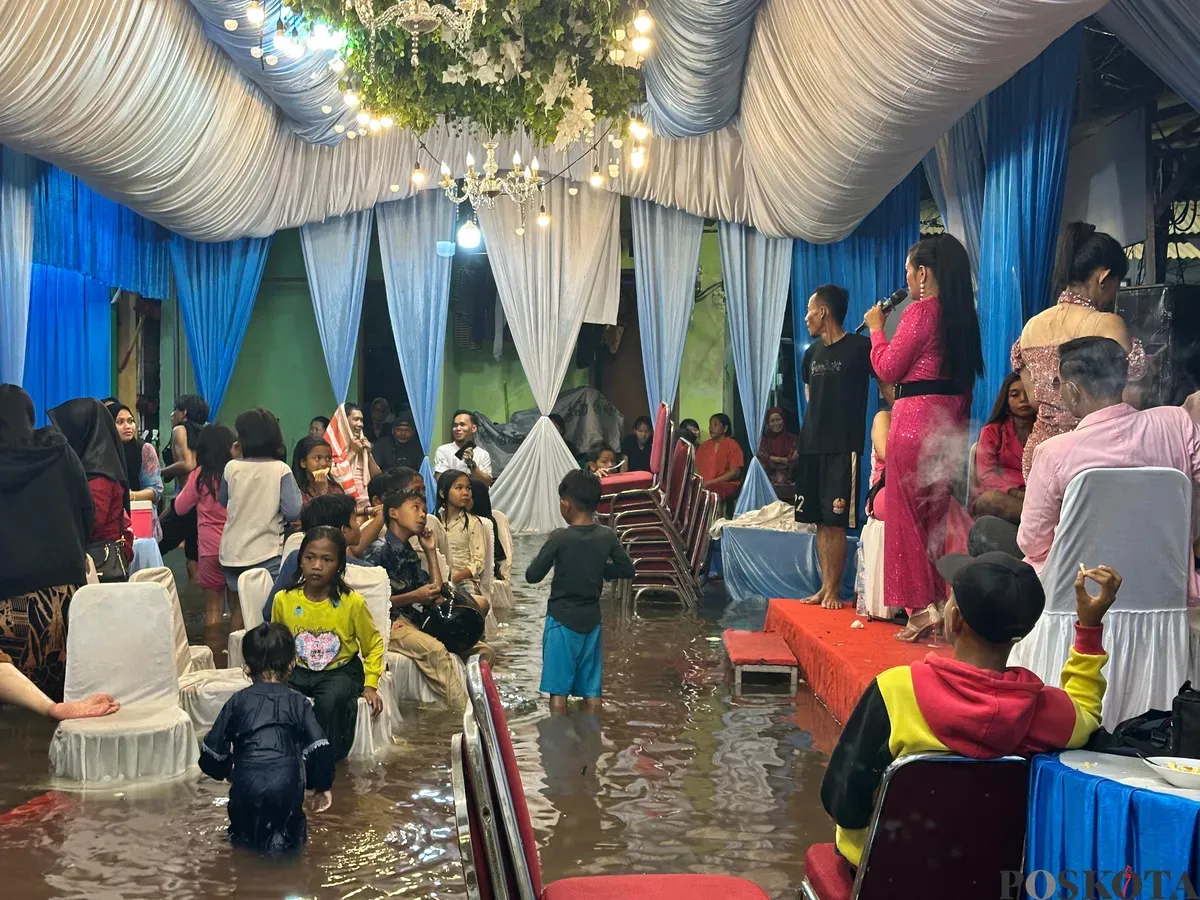 Acara pernikahan warga Muara Angke, Jakarta Utara, tetap berjalan ditengah banjir rob yang melanda, Senin, 23 Juni 2025. (Sumber: Poskota/Pandi Ramedhan)