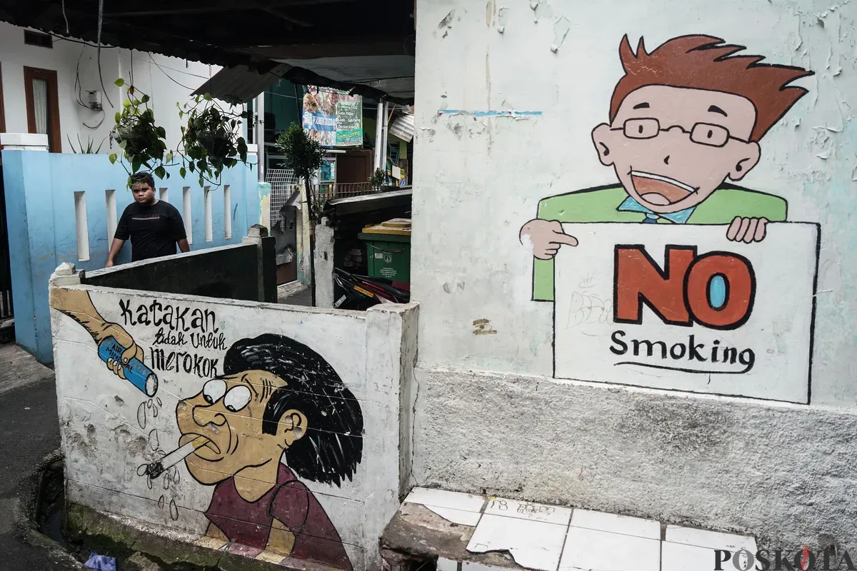 Warga berjalan melewati mural anti rokok di permukiman padat penduduk Matraman, Jakarta, 24 Juni 2025. (Sumber: Poskota/Bilal Nugraha Ginanjar)