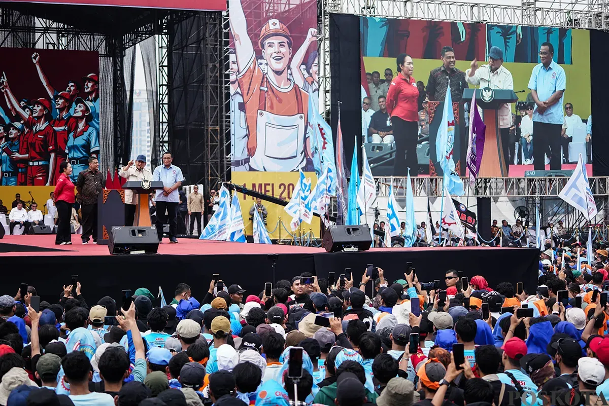 Presiden RI Prabowo Subianto berbicara dari podium di depan ribuan massa buruh yang tergabung dari berbagai serikat kerja memadati kawasan Monumen Nasional (Monas), Jakarta, untuk memperingai Hari Buruh Internasional pada Kamis, 1 Mei 2025. (Sumber: Poskota/Bilal Nugraha Ginanjar)